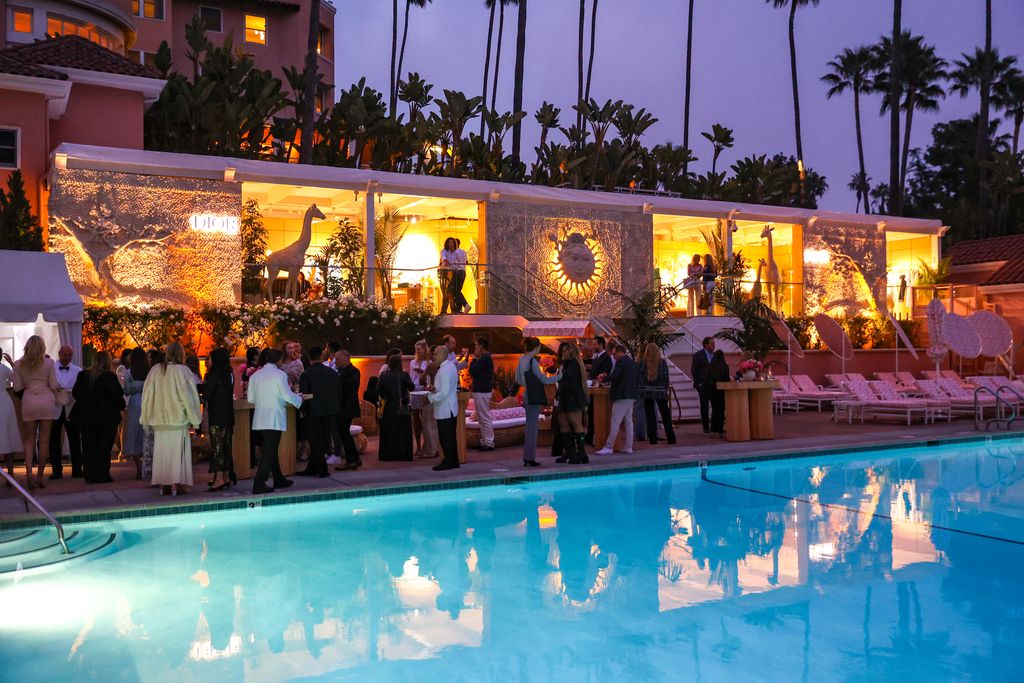 An evening reception around a softly lit pool.